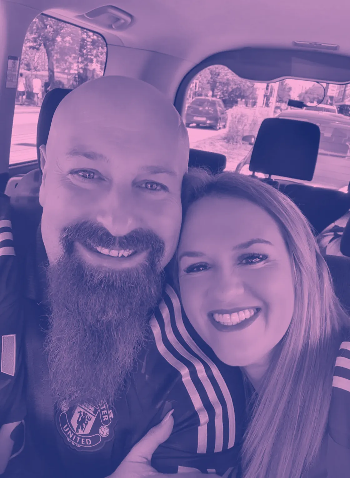 Neil Lock and Natalie Lock, co-founders, beside a car